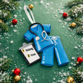 Load image into Gallery viewer, Personalized nurse ornament featuring blue medical scrubs with stethoscope and clipboard design. Custom name and year displayed on the ornament. Smooth resin finish with mostly 2D structure and raised 3D front details. Ideal Christmas ornament for nurses healthcare workers and medical professionals celebrating the holiday season.
