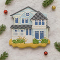 Load image into Gallery viewer, Decorative house ornament on a textured surface with Christmas decorations.
