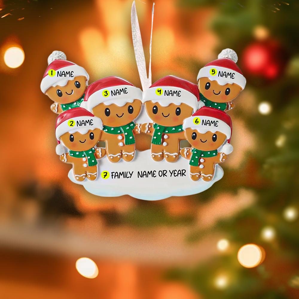 Personalized gingerbread family Christmas ornament with customizable names on a blurred Christmas tree background.