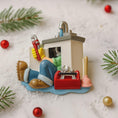 Load image into Gallery viewer, Decorative ornament of a plumber with tools on a white background with Christmas decorations.

