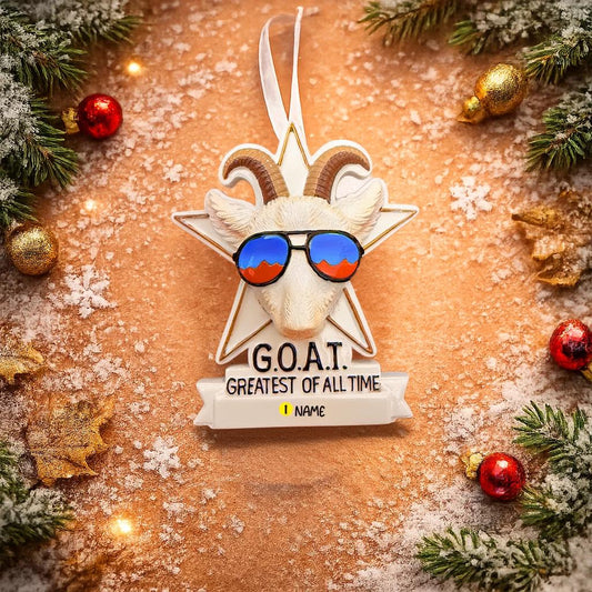 Decorative ornament with goat head, sunglasses, and 'G.O.A.T.' text on a festive background.