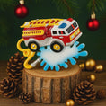Load image into Gallery viewer, Toy fire truck on a wooden stump with Christmas decorations in the background
