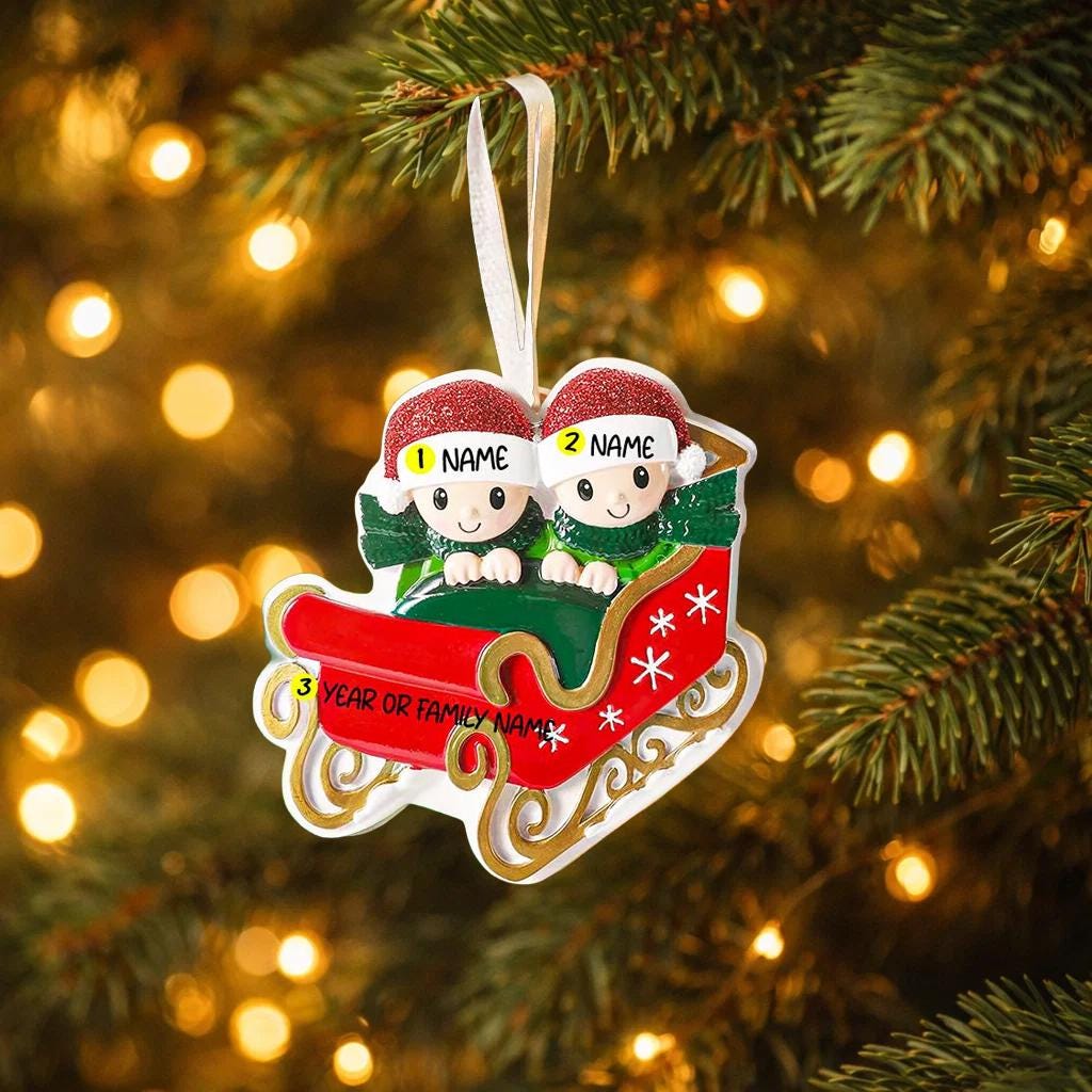 Personalized couple ornament featuring two characters sitting together in a festive sleigh design. This romantic Christmas ornament can be customized with two names and a year or family name, making it perfect for couples, partners, spouses, fiancés, or loved ones. Ideal for celebrating love, togetherness, Valentine’s Day, anniversaries, or first holidays together. A meaningful keepsake for couples who want to turn shared moments into lasting holiday memories.
