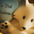 Load image into Gallery viewer, Polar bear figurine with 'First Christmas' text on a blue background
