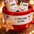 Load image into Gallery viewer, Personalized couple ornament featuring two smiling characters inside a cozy holiday mug design. This romantic Christmas ornament can be customized with two names and a family name or year, making it perfect for couples, partners, spouses, fiancés, or loved ones. Ideal for celebrating love, Valentine’s Day, anniversaries, newlyweds, or first holidays together. A warm and meaningful keepsake that captures shared moments and turns them into lasting holiday memories.

