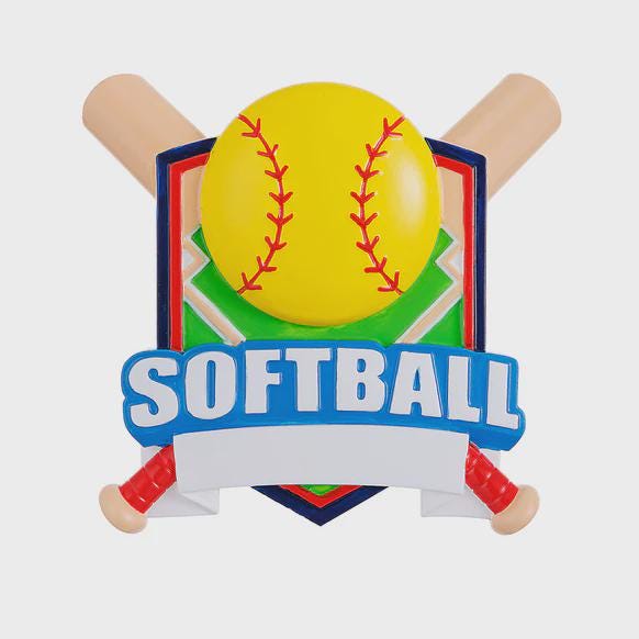 Personalized softball Christmas ornament featuring a yellow softball with stitched details and crossed bats design on a shield style background, customizable name area on the front banner and customizable year area on the softball, glossy finish with raised 3D front details and flat 2D back, white hanging ribbon, displayed on a snowy softball field themed holiday background with pine branches and festive decorations.