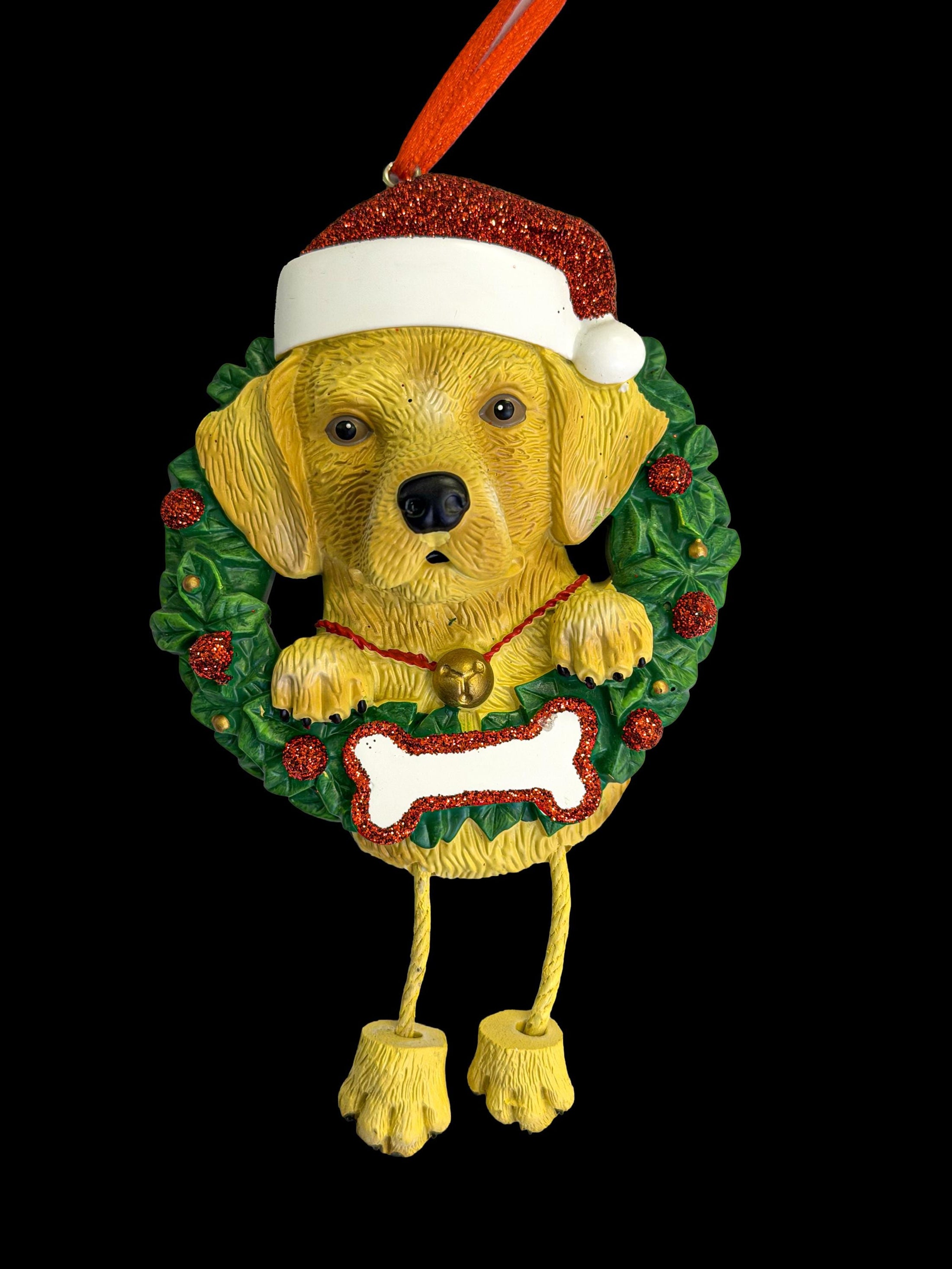 Dog Christmas ornament with a wreath, bone, and Santa hat on a black background