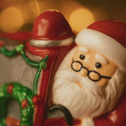 Decorative figurine of a Santa Claus with a blurred festive background