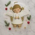 Load image into Gallery viewer, Decorative angel figurine with gold glittery accents on a snowy background
