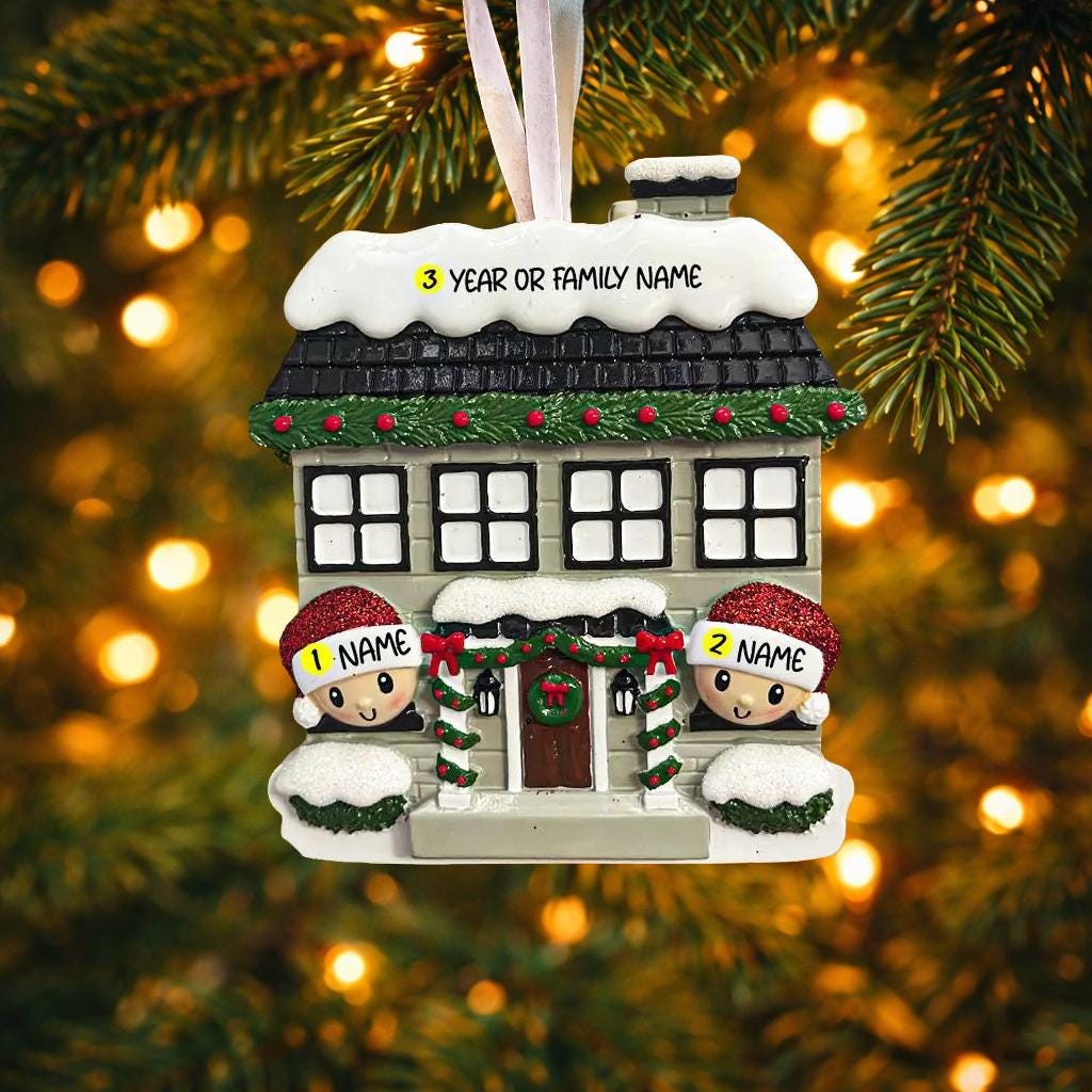 Personalized Christmas house ornament featuring a cozy winter home decorated with snow, wreaths, garlands, and festive details. Two smiling characters wearing Santa hats peek from the front, each customizable with a name, while the roof displays a year or family name. Designed with a detailed 3D raised front and smooth finish, this ornament is perfect for Christmas tree decor, family keepsakes, new home celebrations, and holiday gifting.
