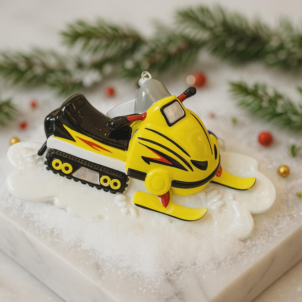 Yellow snowmobile ornament on a decorative base with Christmas decorations