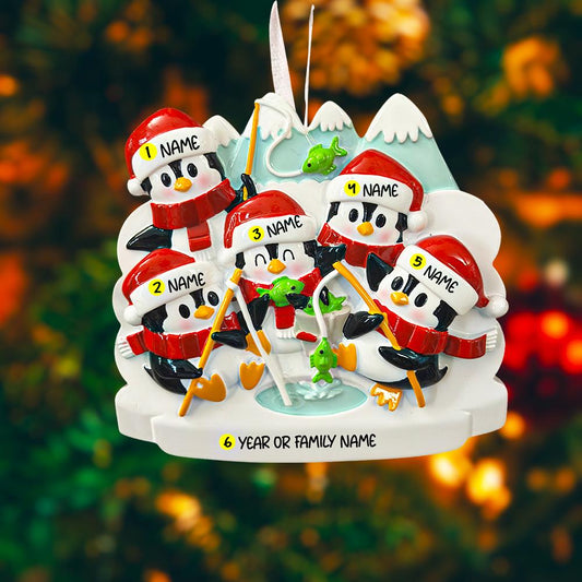 Personalized Christmas ornament with penguins on a mountain, customizable names and year.