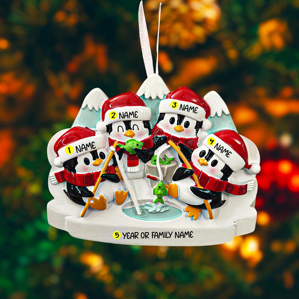 Personalized Christmas ornament with penguins in winter attire on a blurred festive background