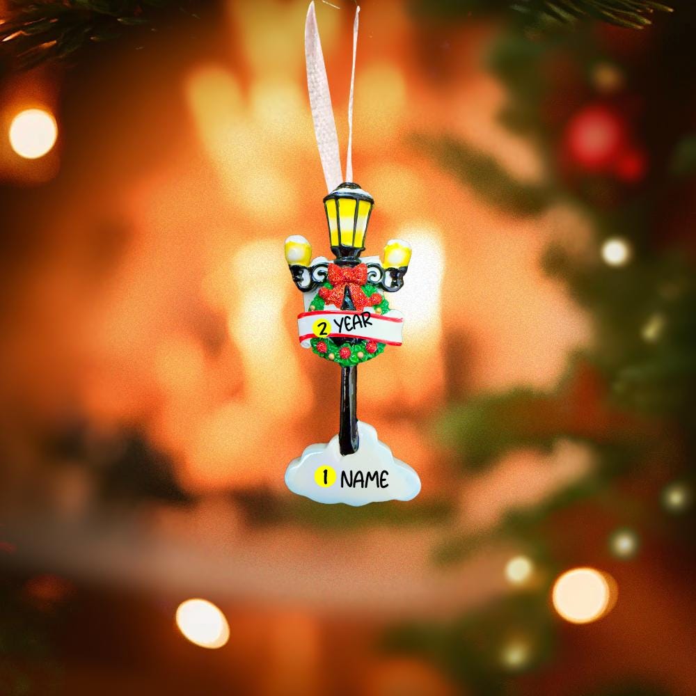 Decorative Christmas ornament with customizable text on a blurred Christmas tree background