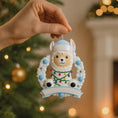 Load image into Gallery viewer, Personalized baby boy llama ornament featuring a cute smiling llama wearing a winter hat and surrounded by a festive wreath with colorful holiday lights. Soft blue and white tones create a cozy winter look. Handwritten personalization includes baby name and Baby’s First Christmas with year. Mostly 2D ornament with raised 3D details on the front only, lightweight and perfect for Christmas trees, nursery decor, and baby keepsakes.
