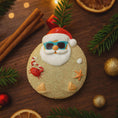 Load image into Gallery viewer, Decorative ornament shaped like a Santa Claus with beach elements on a wooden surface with Christmas decorations.
