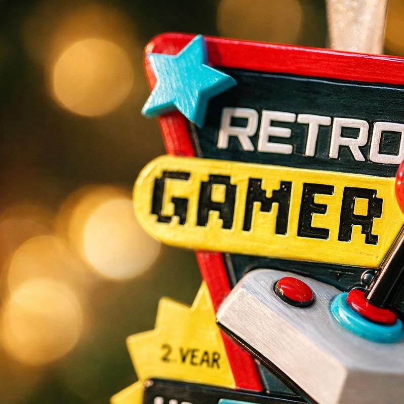Personalized retro gamer Christmas ornament featuring a classic arcade style joystick and bold gaming icons. Raised 3D front details create depth while the back remains flat for easy hanging. Custom name and year placement make this ornament a fun and nostalgic keepsake for gamers and holiday tree decor.