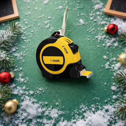 Yellow and black tape measure on a green surface with Christmas decorations