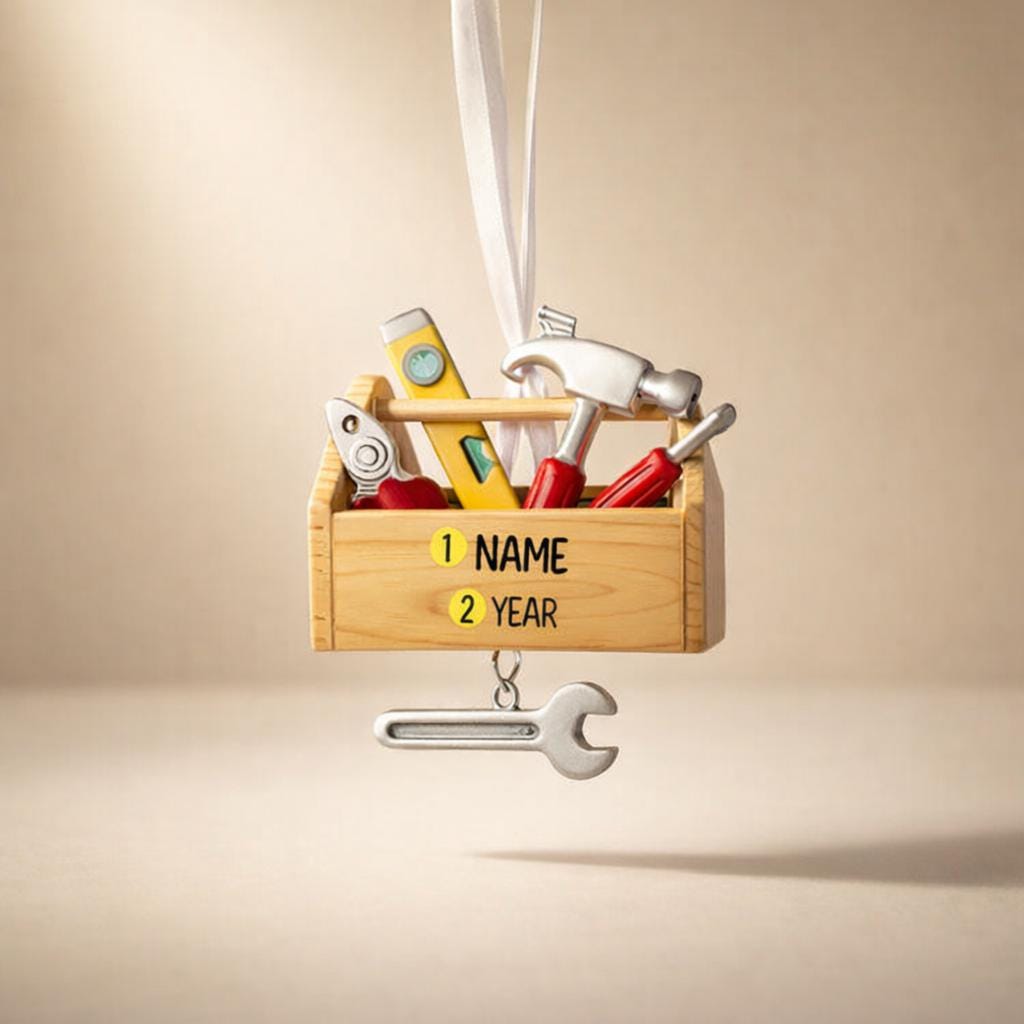 Personalized handyman ornament featuring a wooden style toolbox filled with tools including hammer wrench pliers and level. Custom name and year displayed on the front. Mostly 2D design with raised 3D tool details on the surface. Perfect Christmas ornament for handyman contractors mechanics and skilled trade workers.