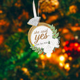 Load image into Gallery viewer, Elegant engagement Christmas ornament featuring gold accents white florals and the phrase she said yes. Personalized with a custom date to commemorate a proposal or engagement moment. A romantic keepsake perfect for celebrating newly engaged couples weddings and meaningful holiday memories.
