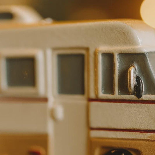 Close-up of a ceramic toy bus with a blurred background