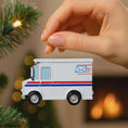 Load image into Gallery viewer, White mail truck ornament held by a hand with a blurred festive background
