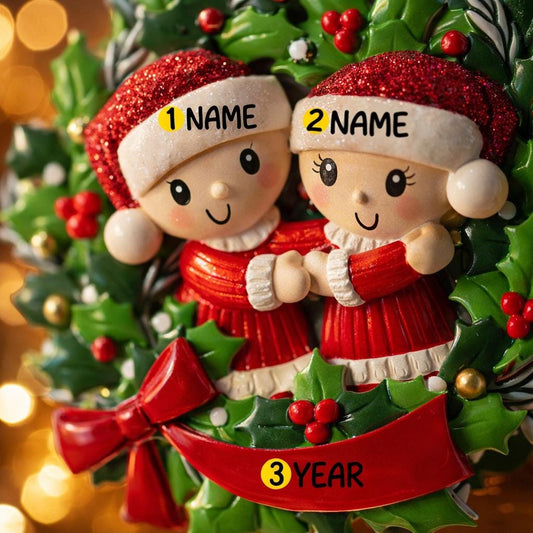 Personalized Christmas ornament with couple in Santa hats and red sweaters, against a festive background.