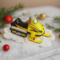 Load image into Gallery viewer, Yellow snowmobile ornament on a decorative surface with Christmas decorations
