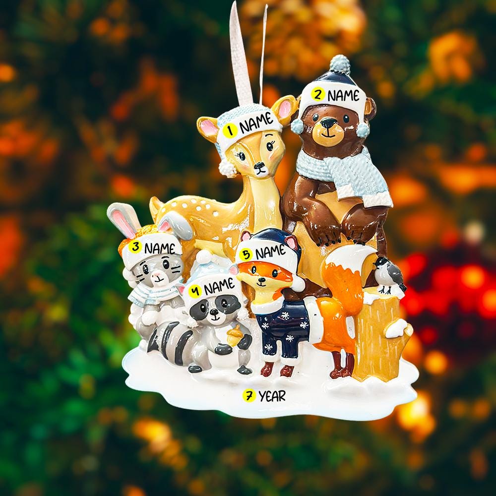 Decorative ornament with cartoon animals wearing winter hats and scarves against a blurred natural background.