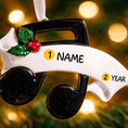 Load image into Gallery viewer, Personalized music note ornament featuring a classic black and white musical note design with subtle holiday accents. Customizable with one name and a year. Crafted from resin with detailed 3D raised front elements and a flat 2D back for balanced hanging. Finished with a glossy surface and satin ribbon. Designed for musicians music students and music themed Christmas tree decor.
