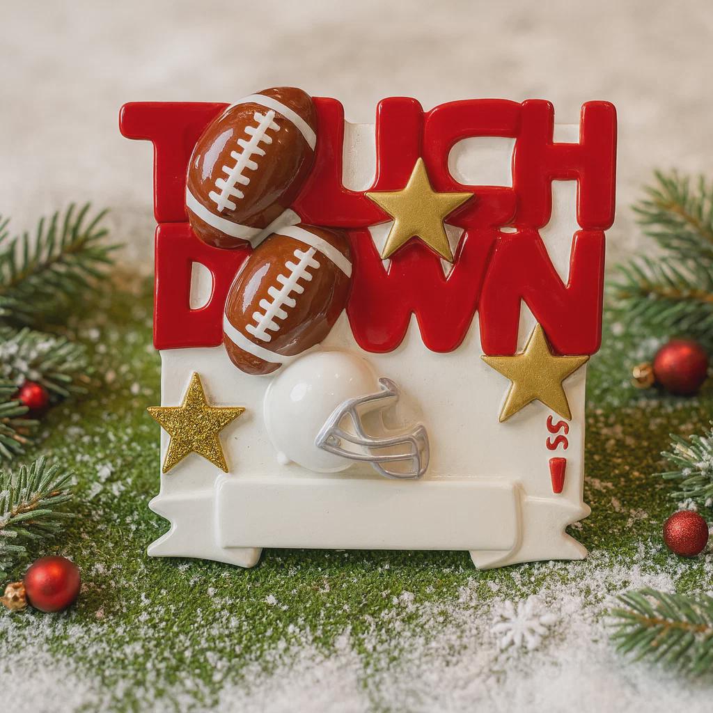 Decorative Christmas ornament with 'Touchdown' text, footballs, and a helmet on a snowy background.
