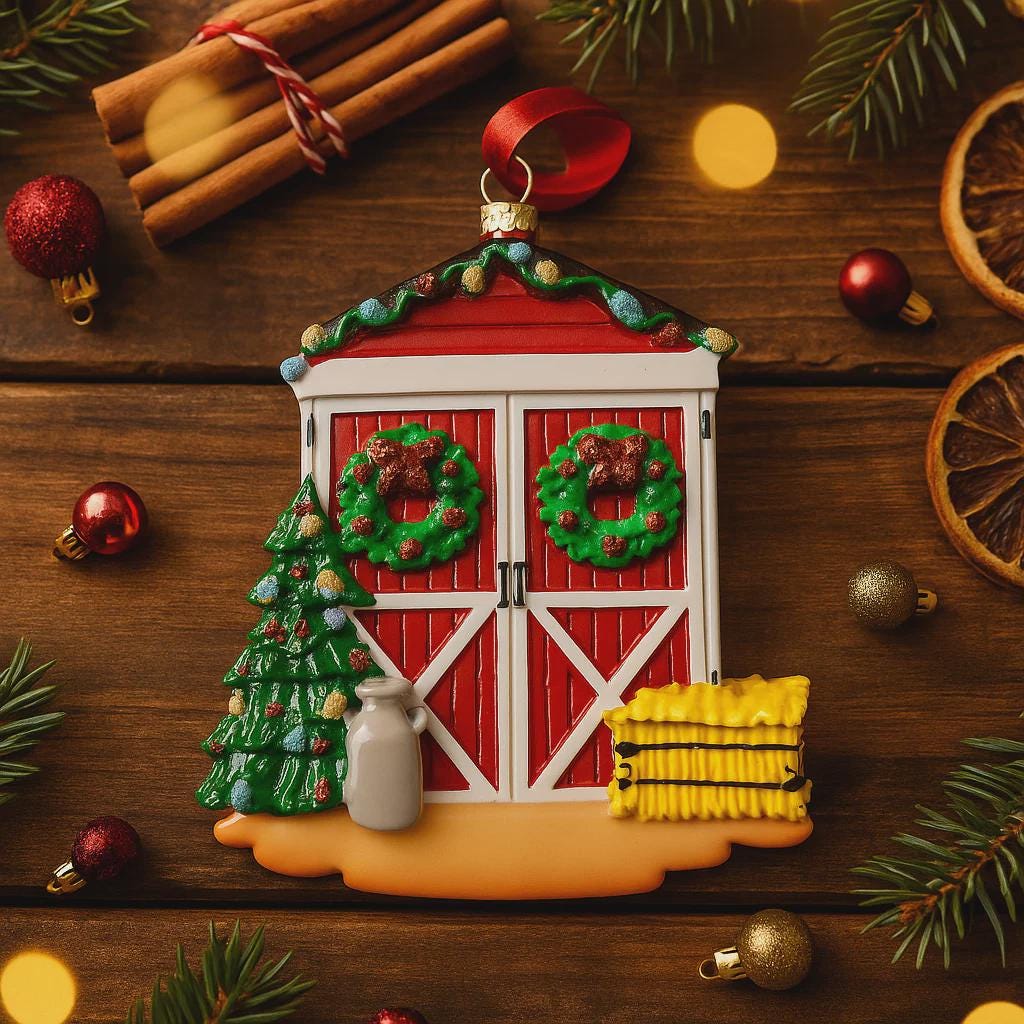 Decorative Christmas ornament resembling a red barn with wreaths on a wooden surface with festive decorations.