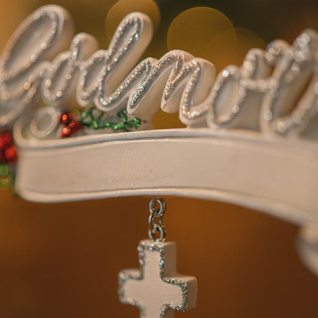 Decorative crown with 'Princess' text and a cross pendant on a blurred background