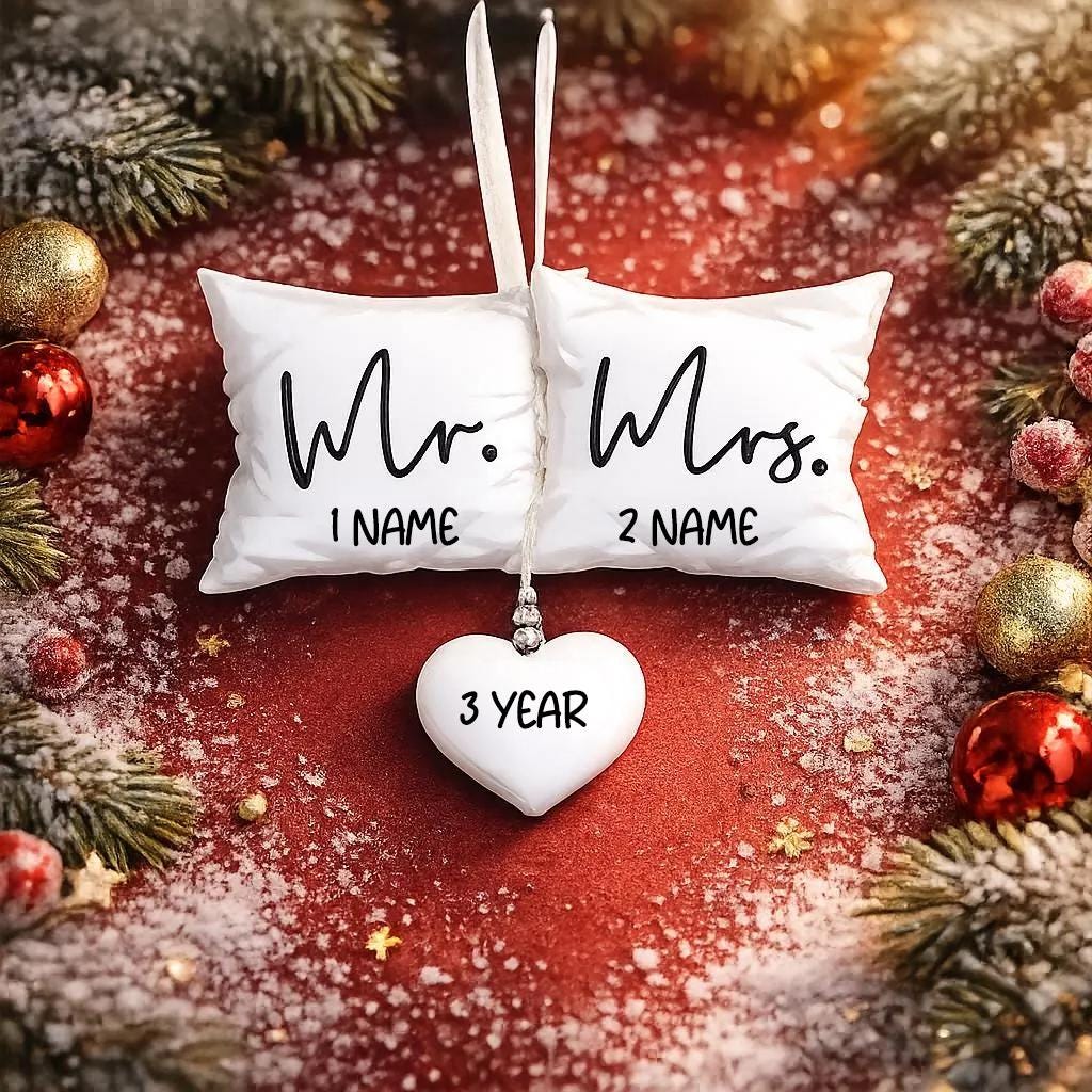 Personalized Mr and Mrs pillow ornament featuring a soft white cushion design with hanging heart detail. A romantic keepsake for newlyweds celebrating their first Christmas married or Valentine’s Day. Perfect wedding gift anniversary decor and couple ornament.