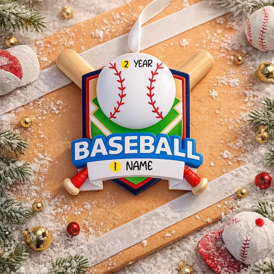 Personalized baseball Christmas ornament featuring a classic baseball and crossed bats design on a shield style background, customizable name area on the front banner and customizable year area on the baseball, glossy finish with raised 3D front details and flat 2D back, white hanging ribbon, displayed on a snowy baseball field themed holiday background with pine branches and festive decorations.
