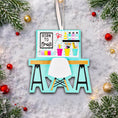 Load image into Gallery viewer, Born to Craft ornament featuring a creative desk scene with colorful craft supplies including scissors paint bottles brushes pencils and storage cups. The ornament showcases a playful crafting workspace design with a modern chair and desk setup. Made from durable resin with a detailed 3D front and flat 2D back for smooth hanging. Includes free handwritten personalization making it a perfect gift for crafters artists DIY lovers and creative kids. Ideal for Christmas trees craft rooms studios and handmade the
