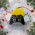 Load image into Gallery viewer, Personalized gamer controller Christmas ornament featuring a raised 3D front with detailed game controller design, including realistic buttons, joystick elements, and bold comic style accents. The ornament has a smooth flat 2D back for easy hanging and long lasting durability on the Christmas tree. The design allows personalization with a name and year clearly displayed on the front, making it a unique holiday keepsake. Bright colors and gaming themed details make this ornament perfect for kids, teens, and 
