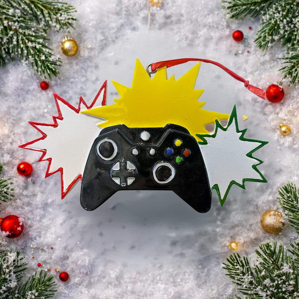 Personalized gamer controller Christmas ornament featuring a raised 3D front with detailed game controller design, including realistic buttons, joystick elements, and bold comic style accents. The ornament has a smooth flat 2D back for easy hanging and long lasting durability on the Christmas tree. The design allows personalization with a name and year clearly displayed on the front, making it a unique holiday keepsake. Bright colors and gaming themed details make this ornament perfect for kids, teens, and 