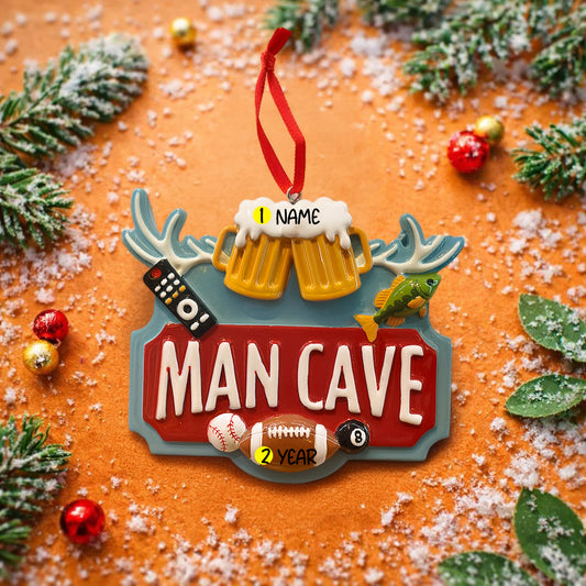 Man cave themed personalized ornament featuring a bold red Man Cave sign design with raised 3D details including beer mugs antlers sports icons and hobby elements. The ornament allows name personalization on the top area and year personalization at the bottom making it a fun and meaningful keepsake. Designed with a flat back for easy hanging this ornament is perfect for man cave decor Christmas trees or gift displays. Ideal for dads husbands boyfriends and anyone who loves their personal space traditions an