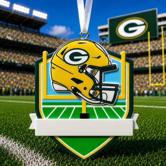 Officially licensed Green Bay Packers painted resin ornament in bright yellow, dark green, blue, white, black, and silver, shaped like a football field with zero characters, one raised helmet, yellow goalposts, glossy cartoon style 3D details, stadium lights, a white hanging ribbon, no snow or glitter, and a white front banner for a handwritten name and optional year.