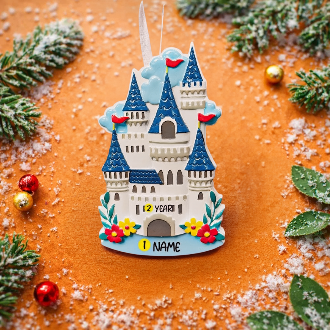 Personalized Princess Castle Christmas Ornament featuring a charming white fairytale castle with blue rooftops and red flags, surrounded by colorful floral details. Customizable with name at the base and year on the castle front, this magical princess castle ornament is perfect for celebrating a special little girl. 