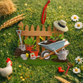 Load image into Gallery viewer, Personalized gardener ornament featuring a detailed garden scene with wooden fence wheelbarrow potted plants gardening tools and soil elements. The design includes a customizable name on the fence and a year on the base making it a thoughtful keepsake for garden lovers. The ornament has a warm rustic farmhouse style and is displayed with a red hanging ribbon suitable for Christmas trees seasonal decor and gift displays.
